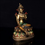 miling and compassionate Green Tara with gilded body and polychrome decoration