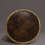 close-up of the bottom of this statue, we can clearly see a sacred cross vajra mark