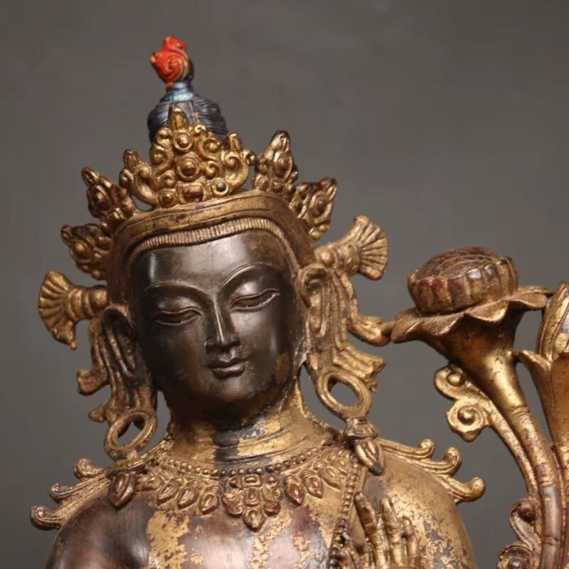 Ornate multi-lobed crown topped with red jewel finial, spiral dangling earrings, naturally abraded gilding statue