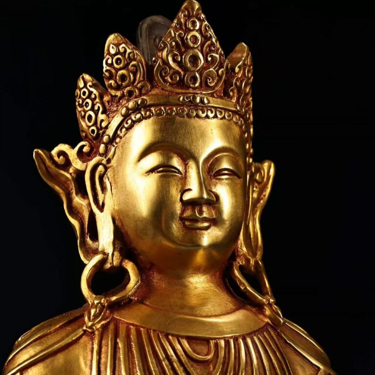 The standing Sandalwood Buddha, with serene expression and golden luster