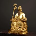 Gilt bronze seated Statue of Sun Simiao, the King of Medicine, holding a dragon-headed cane with a gourd hanging on it