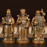 Three antique bronze statues of Fu Lu Shou standing together, representing fortune, prosperity, and longevity in Chinese culture