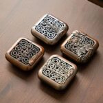 Four square bronze-tone censers engraved with plum, orchid, bamboo and chrysanthemum motifs