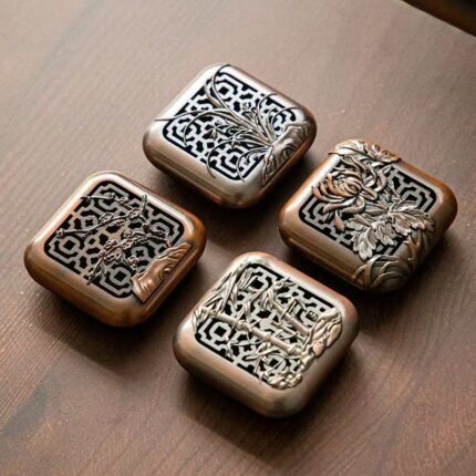 Four square bronze-tone censers engraved with plum, orchid, bamboo and chrysanthemum motifs