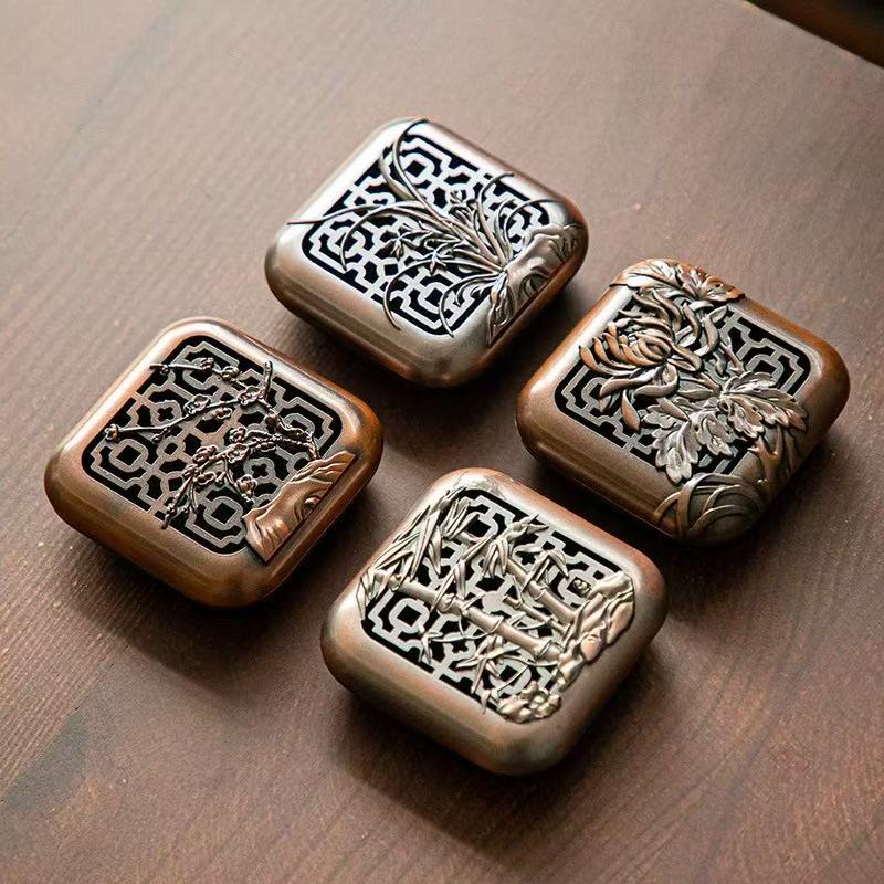 Four square bronze-tone censers engraved with plum, orchid, bamboo and chrysanthemum motifs